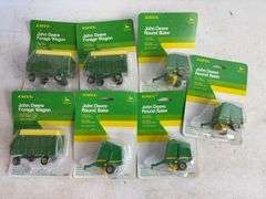 (7) John Deere diecast model toys - (3) forage wagons and (4) round balers