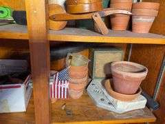 (3) shelves of gardening items including planters, sprinklers, small hose & more