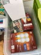 Contents of shelving including lightbulbs, screw-in hooks & more