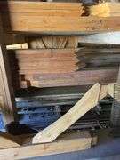 Assortment of stacked lumber. Under roof, lots of 8ft & 10ft variety of species Buyer responsible fo