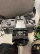 Suitcase, camera with bag, antique General Electric speaker, tin, and more