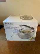 Flat of costume jewelry - mostly bracelets and earrings, and jewelry cleaner