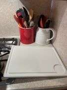 Cutting board and crock with miscellaneous kitchen utensils