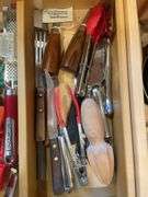 Contents of drawer including silverware, kitchen utensils & misc.