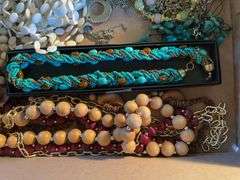 Flat of costume jewelry - mostly necklaces