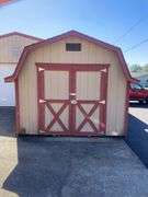 10x12 tan and red storage barn - contents not included