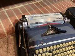 Antique Adler typewriter with case
