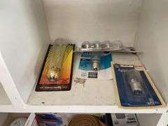 Contents of shelving including lightbulbs, screw-in hooks & more