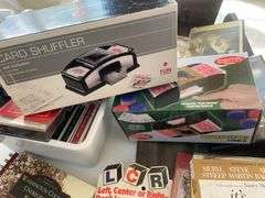 Lot of games & movies including card shuffler, playing cards, LCR & others