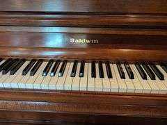 Young piano with bench seat