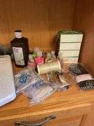 Shelf of bathroom contents - toiletries, cleaning supplies, and more