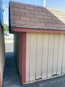 10x12 tan and red storage barn - contents not included