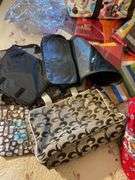 Large assortment of purses, tablecloths, and storage bags