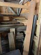 Assortment of stacked lumber. Under roof, lots of 8ft & 10ft variety of species Buyer responsible fo