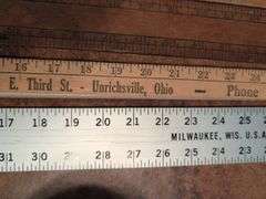 Advertisement yard sticks and (2) Dresden clocks