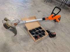 Black and Decker electric trimmer with charger and extra line/caps