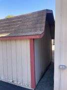 10x12 tan and red storage barn - contents not included