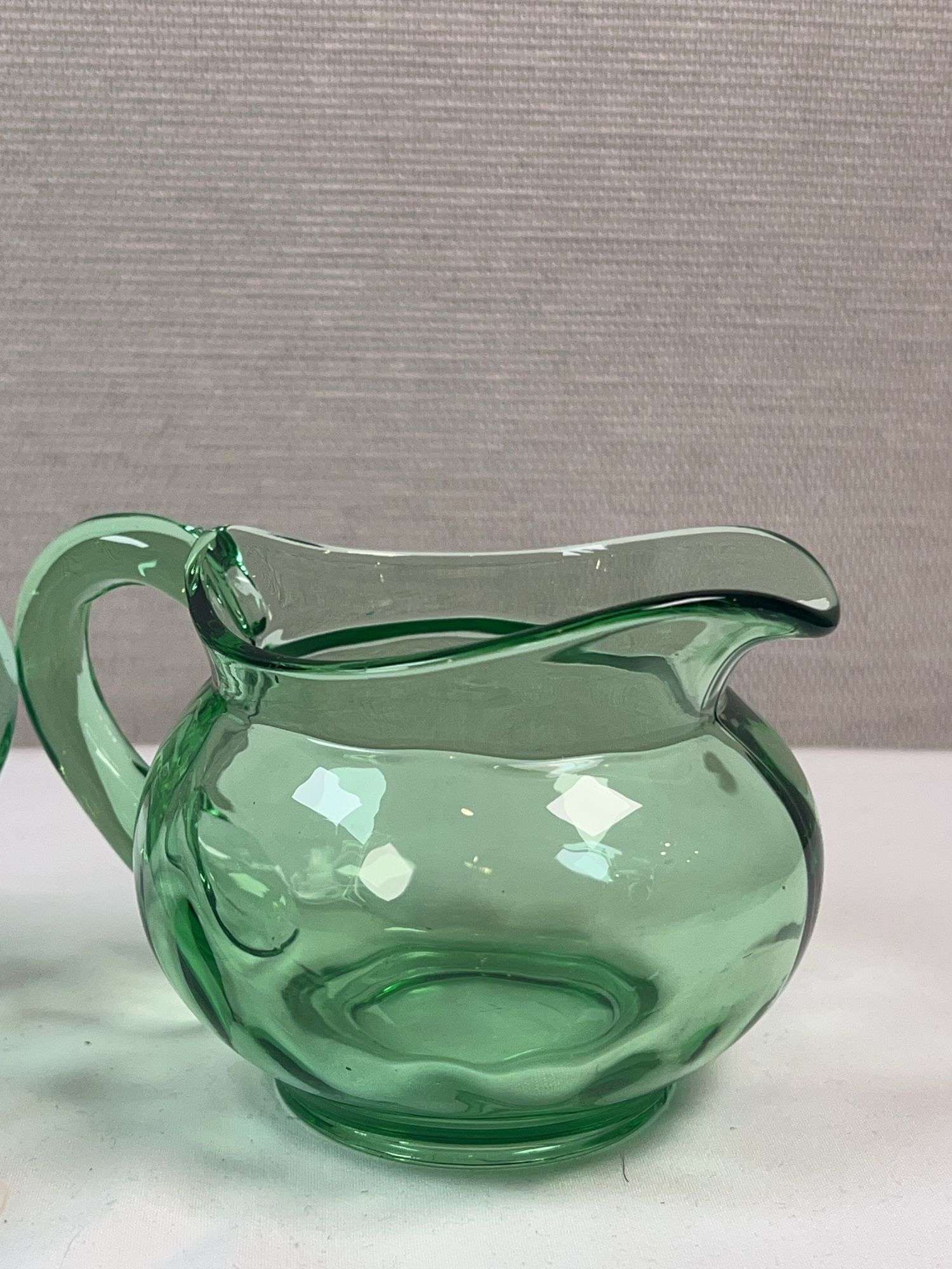 PAIR OF GREEN GLASS HEISEY CREAM AND SUGARS. NO LIDS
