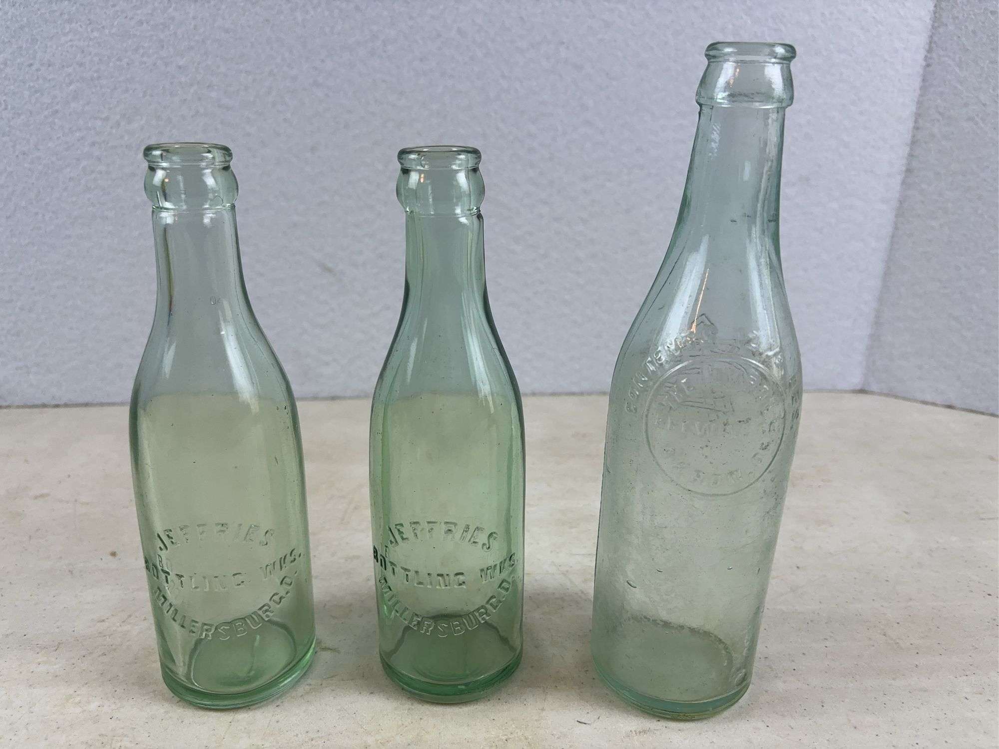 2 Jeffries Millersburg glass bottles and Akron brewing co. bottle