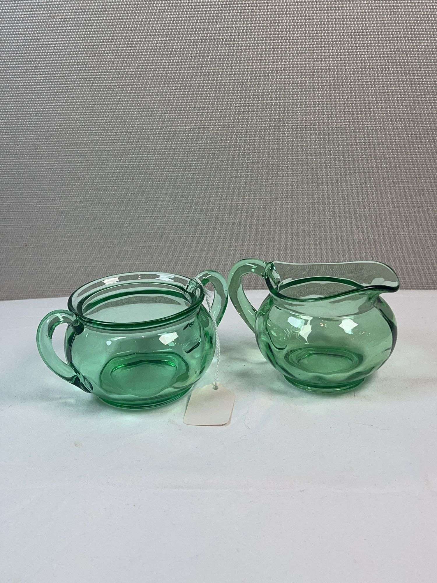 PAIR OF GREEN GLASS HEISEY CREAM AND SUGARS. NO LIDS