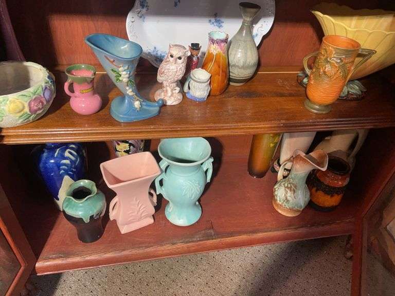 (2) shelves of glassware including Roseville, McCoy & others - w/ antique cabinet