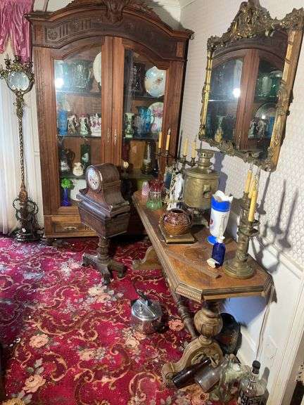 Double door cabinet with contents, decor, mirror, stand, and more