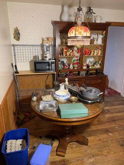 Antique wooden cabinet & dining table w/ glass figurines, pots & pans & misc.