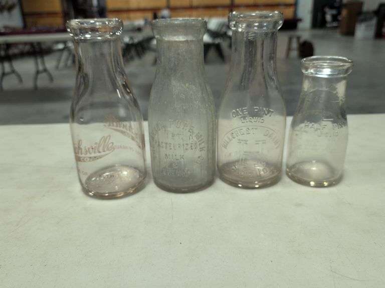 (4) milk bottles - Hillcrest Dairy, Uhrichsville Ice, Akron pure milk, and Massillon