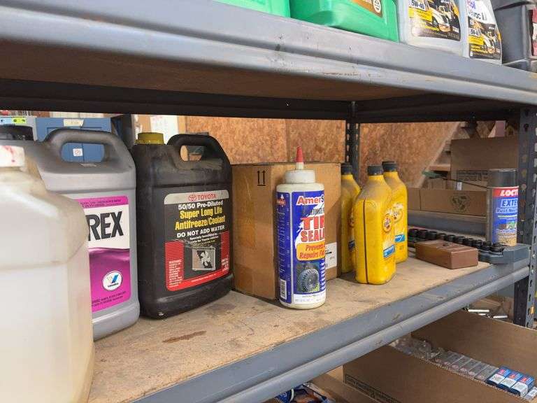 Contents of shelf including (5) quarts Pennzoil transmission fluid, box LV black silicone, antifreez