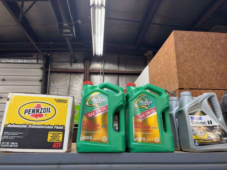 Contents of top shelf including Quaker State full synthetic oil, Mobil Delvac Heavy duty diesel oil 
