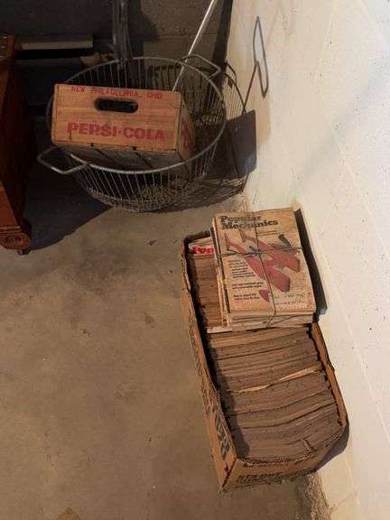 Box of old books and Pepsi crate and basket