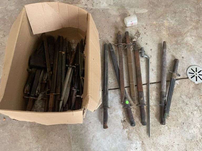 Large assortment of swords and daggers with sheaths