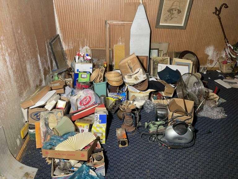 Decorative pieces, cookie jar, ironing board, boxed items, lantern, framed photos, and more