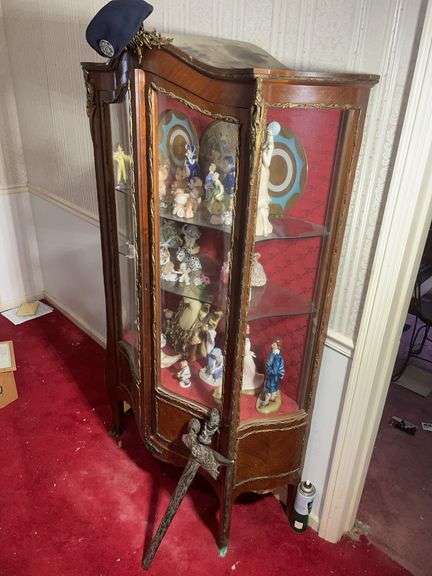 Cabinet of decor, sword, vintage money, Barbie dolls, stuffed animals, and more
