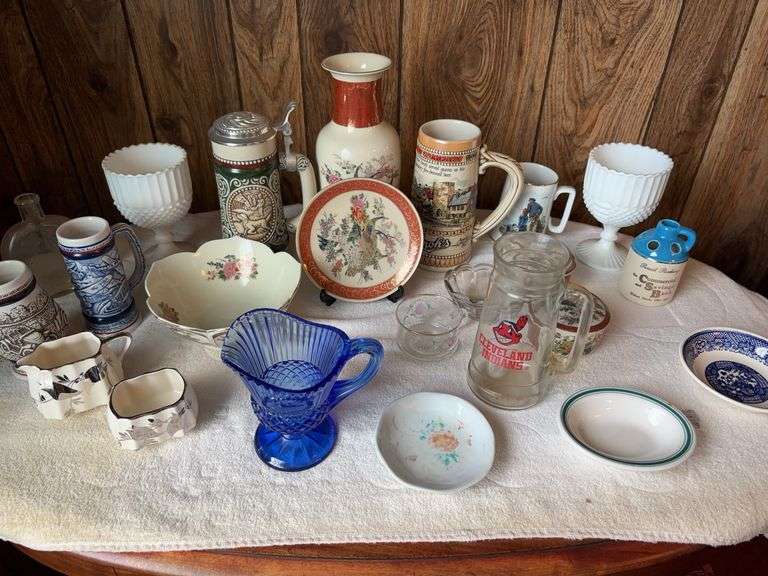 Table of glass bowls, plates, cups, and mugs