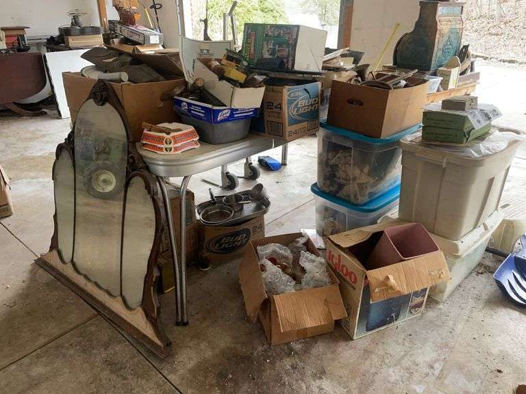 Table with contents - decorative pieces, mirror, vintage items, glassware, books, shovel and more