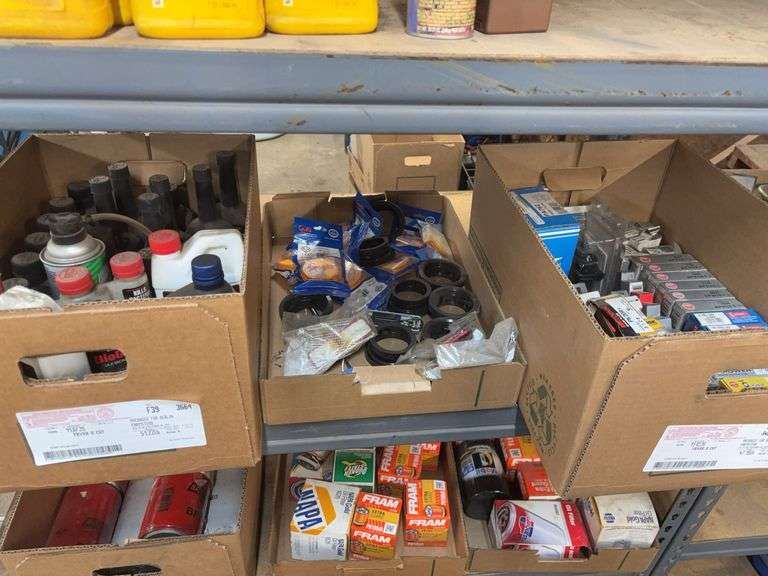 Contents of shelf including box of spark plugs, assortment of oils, fuel system cleaner, E350 Ford 2