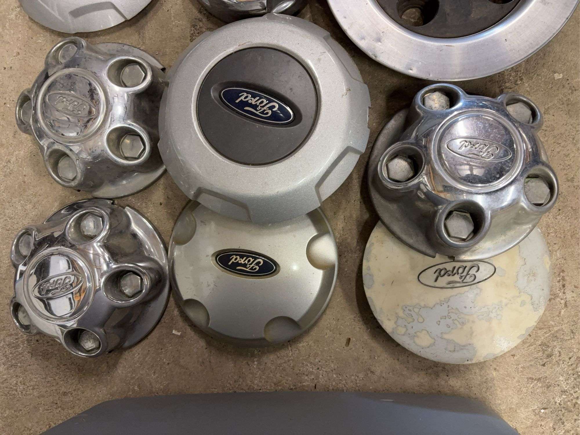 Tote of Ford hub caps and parts