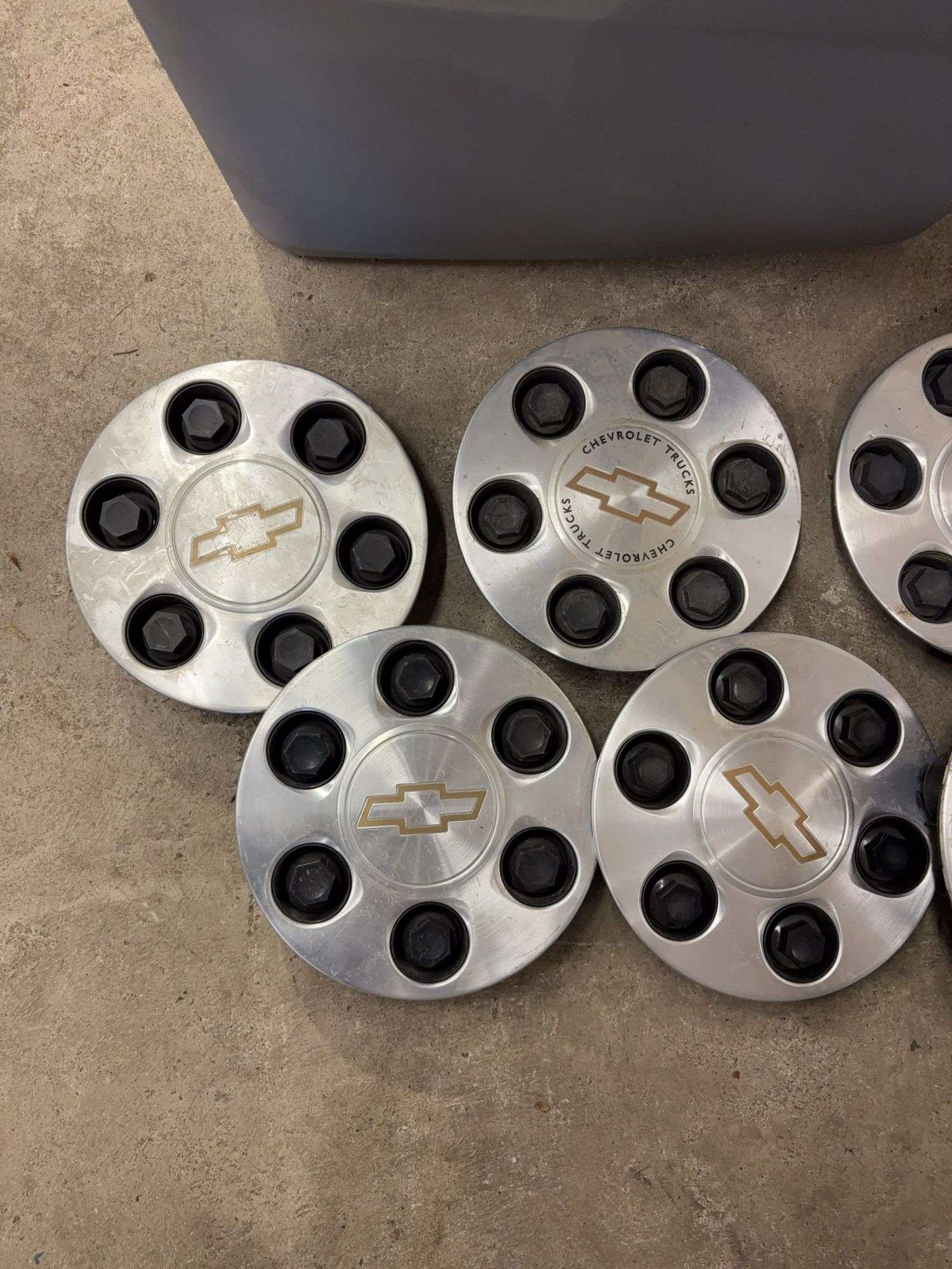 Tote of Chevy hub caps and parts
