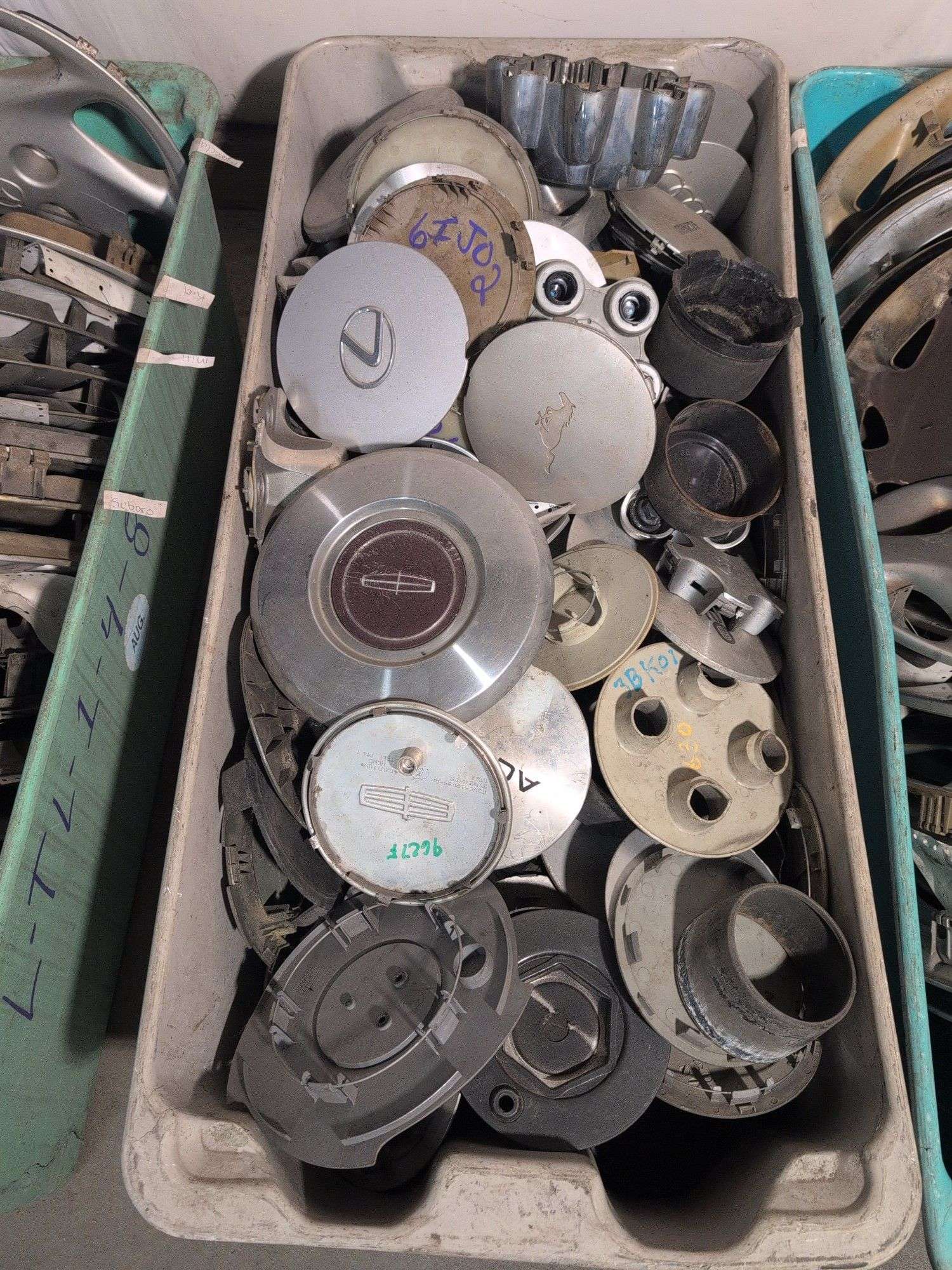 Tote of hubcaps/center caps - Acura, Nissan, Ram, and many more