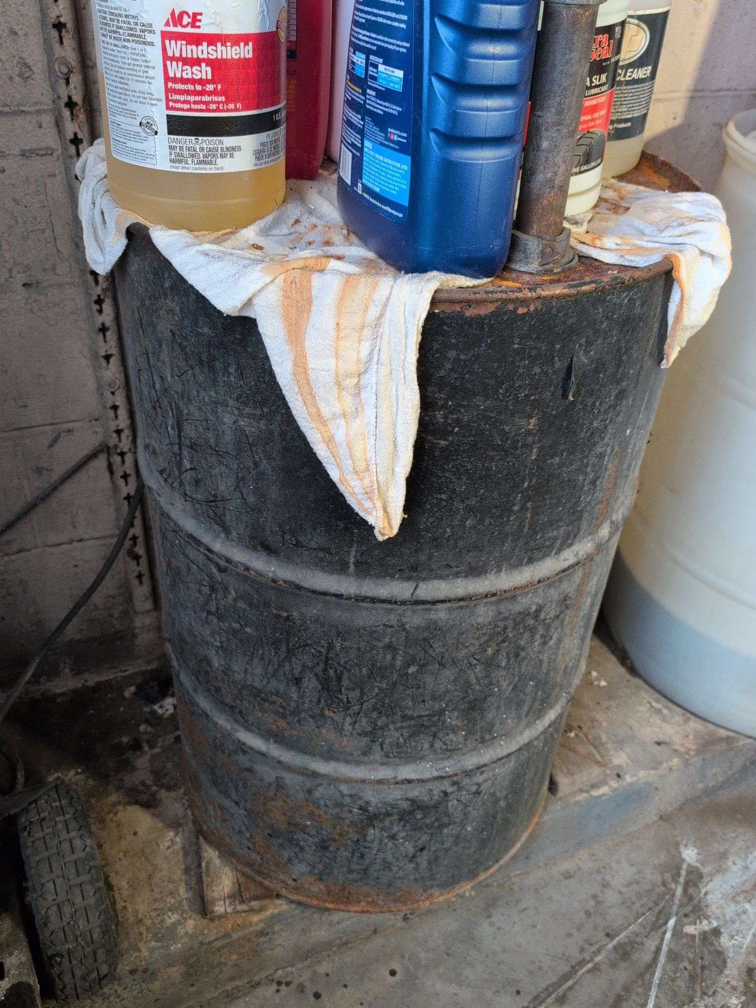 55 gallon metal drum with some antifreeze