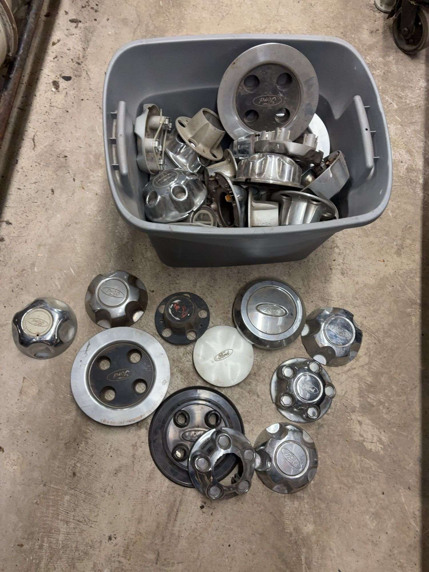 Tote of Ford hub caps and parts