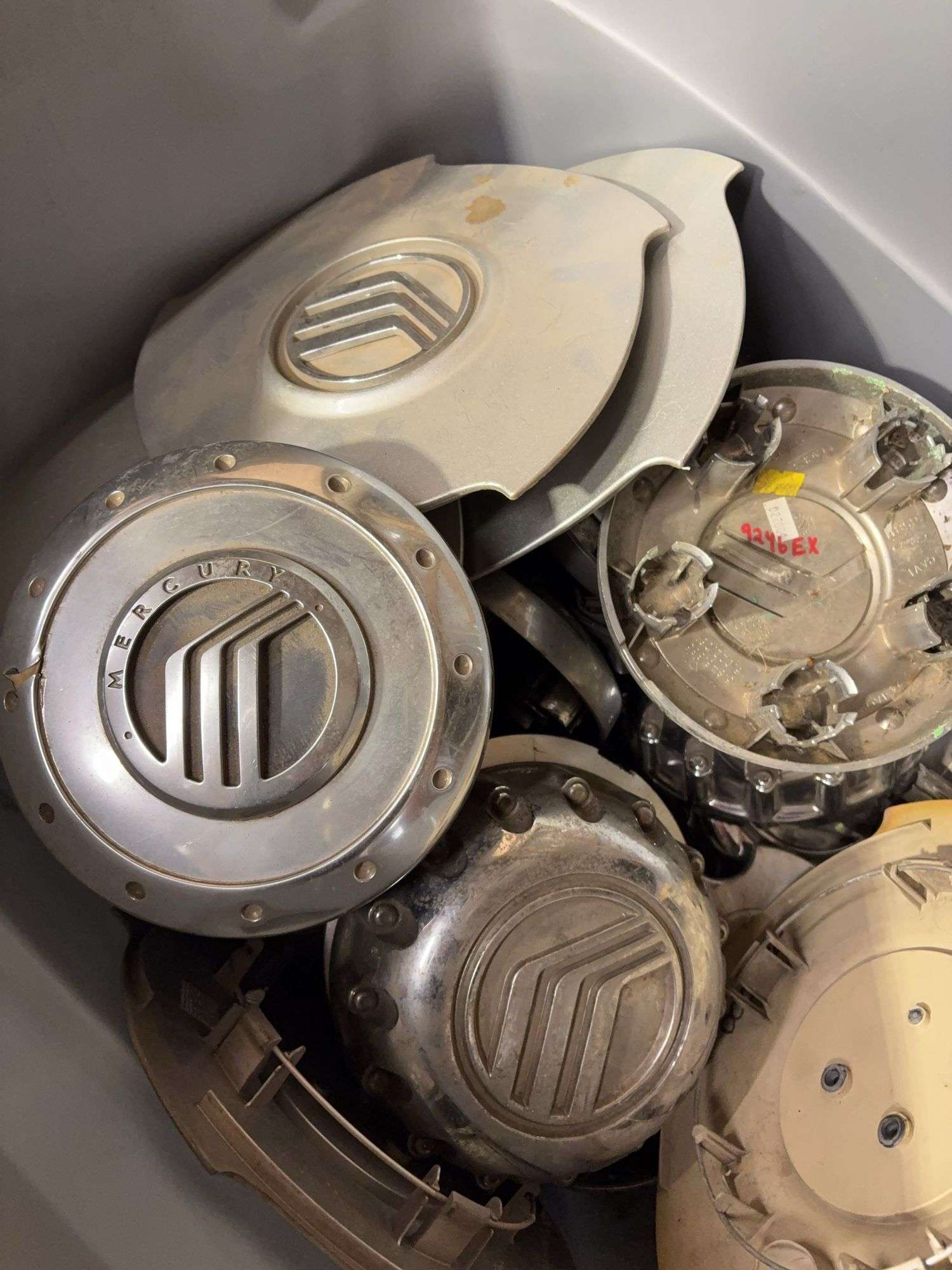 Tote of Miscellaneous hub caps and parts -see photos