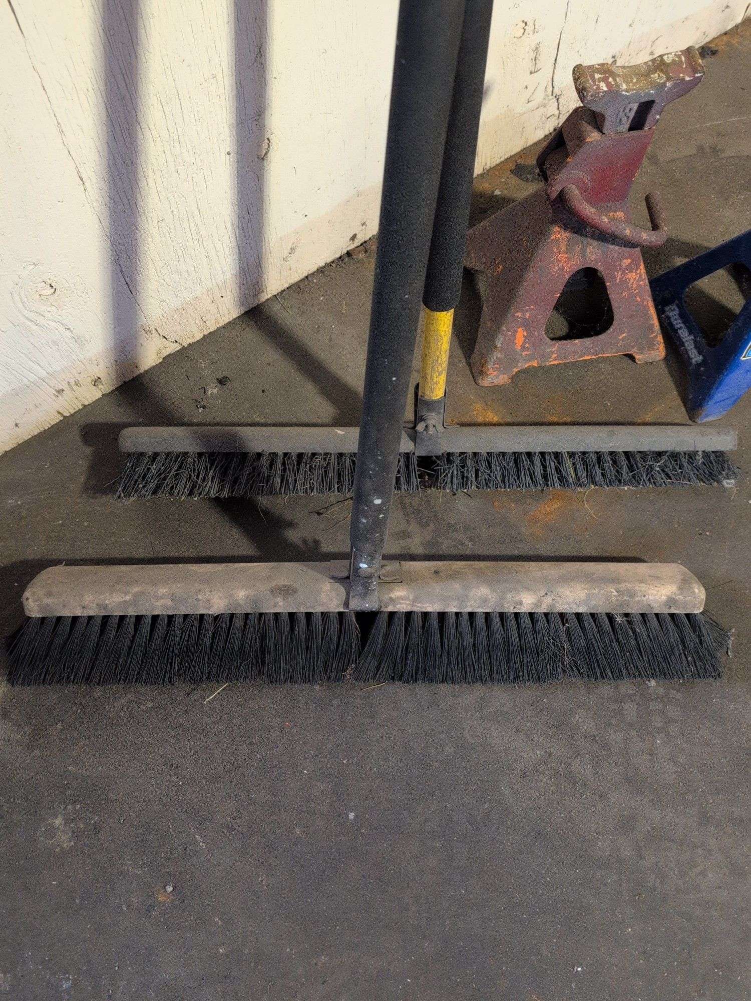 (2) shop brooms and (2) jack stands