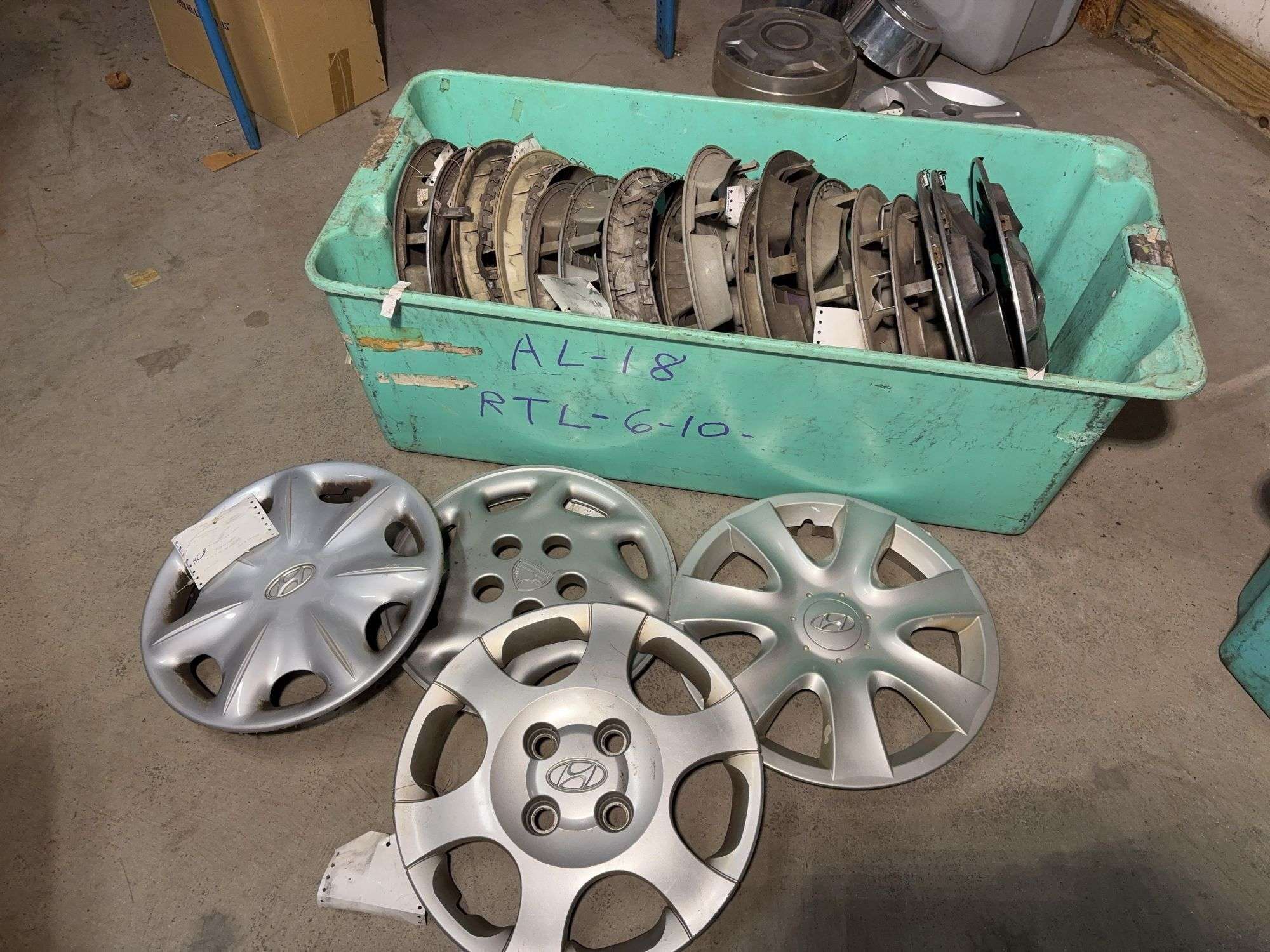 Large tote of hub caps and parts -Hyundai, Eagle and more