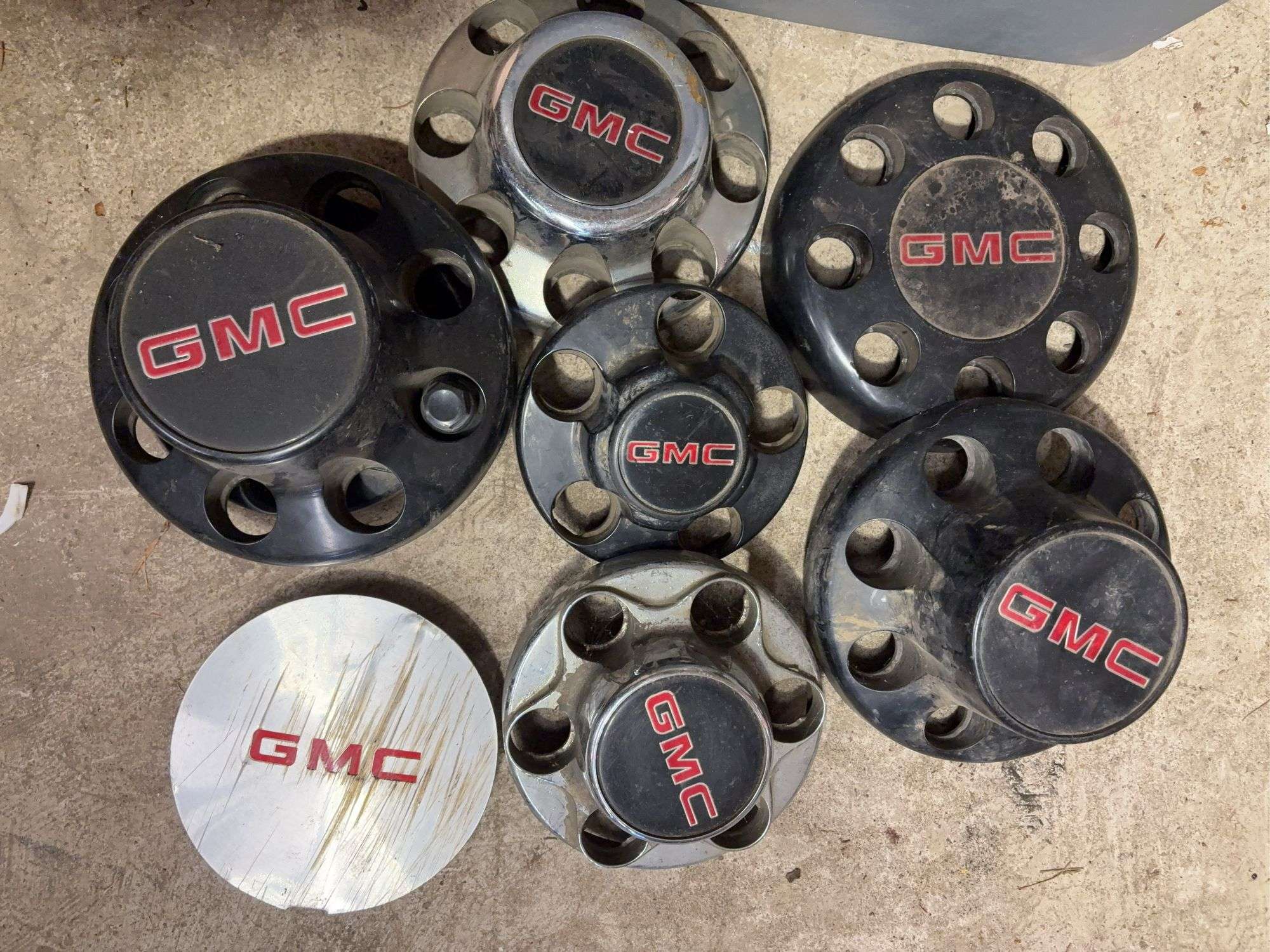 Tote of GMC hub caps and parts
