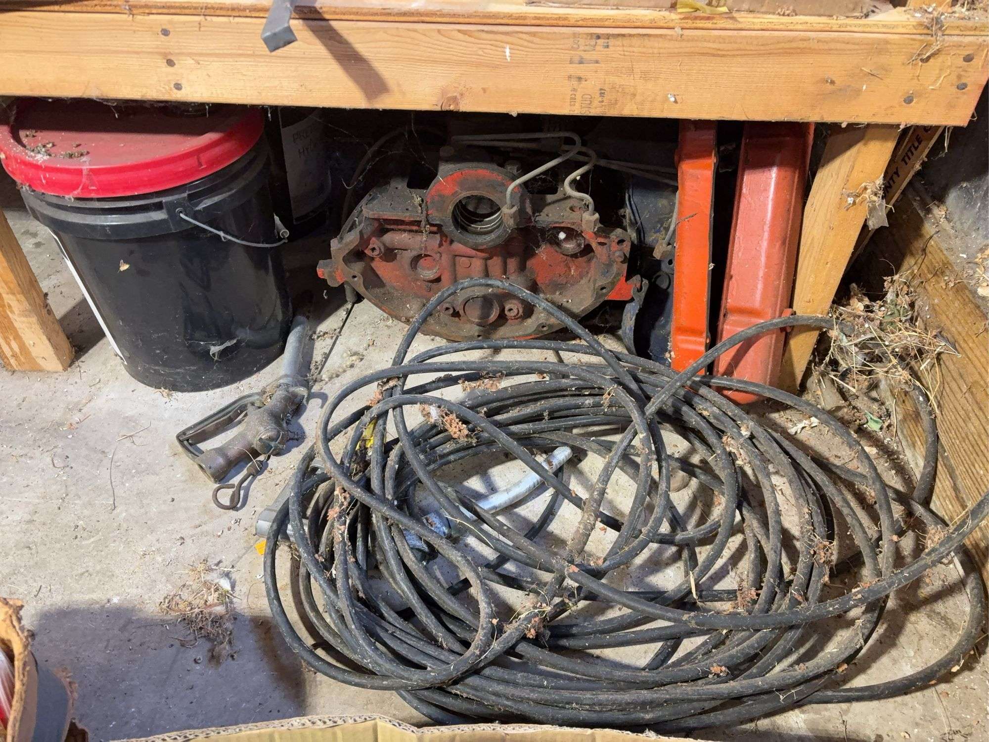 Bucket of hydraulic oil, extension cord, gas nozzles, and more