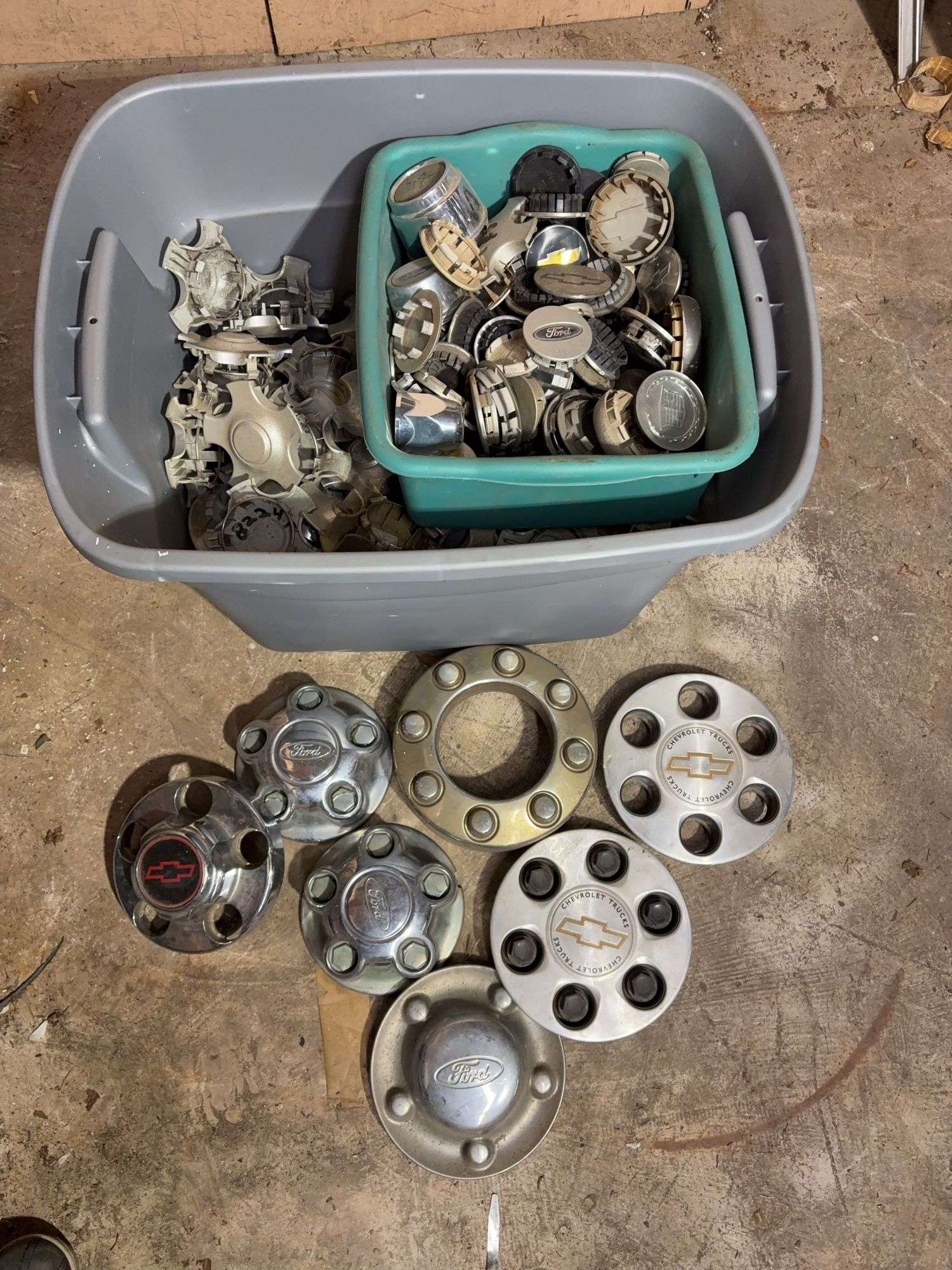 Tote of Chevy and Ford hub caps and parts