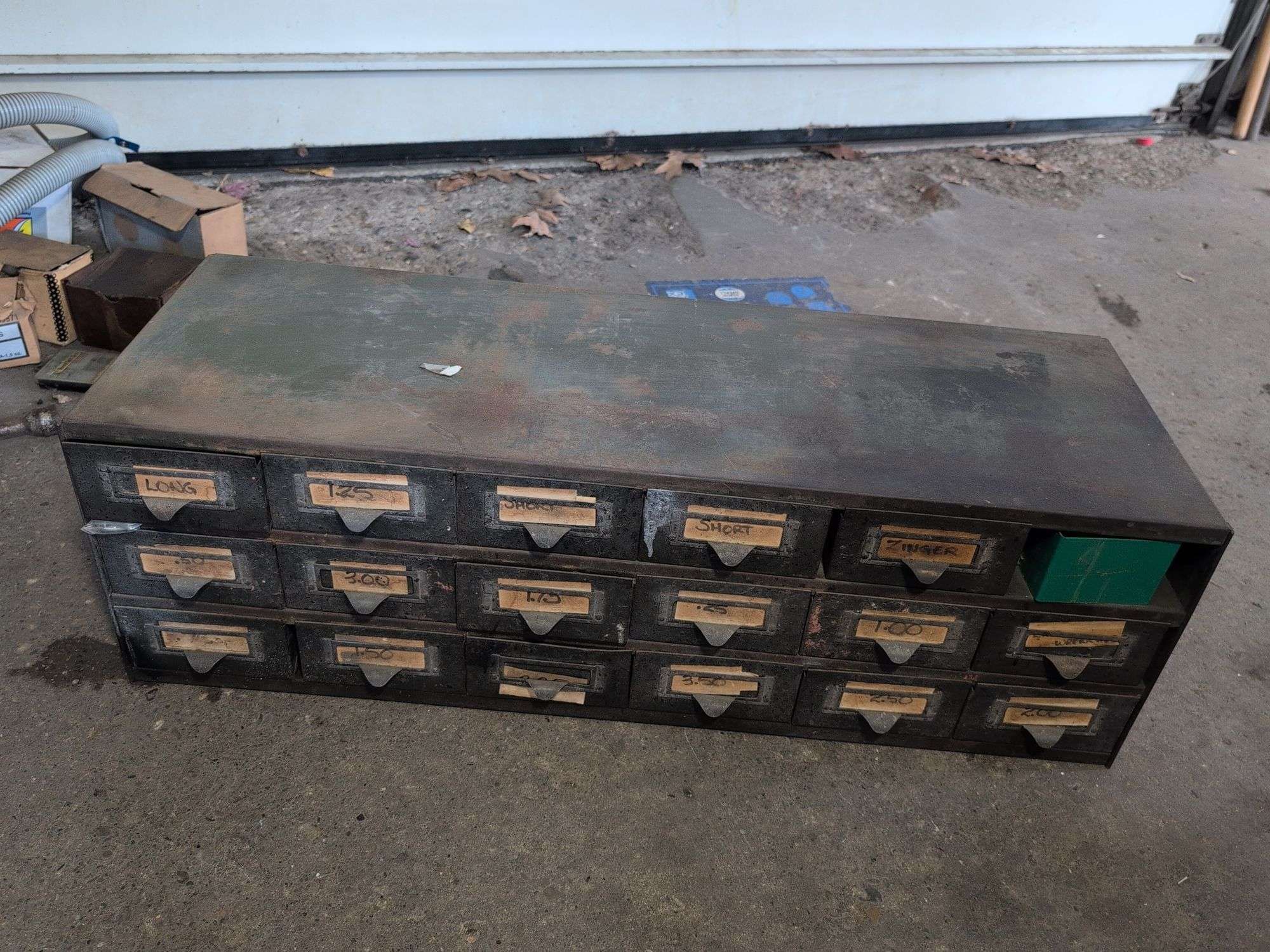 Metal hardware cabinet with nuts and bolts