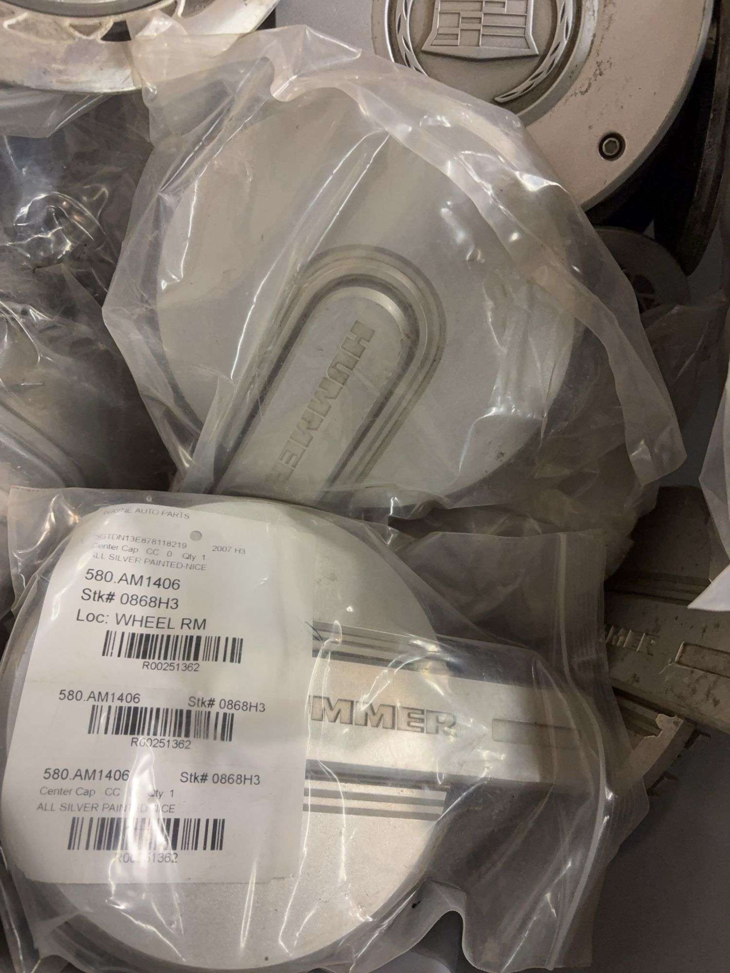 Tote of hub caps and parts -Ford, Oldsmobile and more